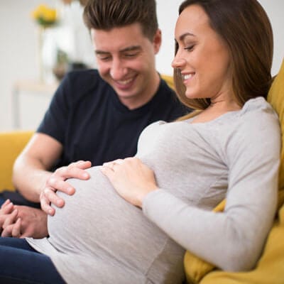 pregnant-couple-relaxing-sq-400.jpg - River City Wellness