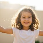 Natural treatment for childhood allergies Austin - happy child playing outdoors after effective allergy relief